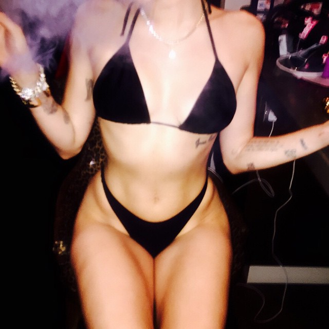 Miley Cyrus smoking up in a black string bikini