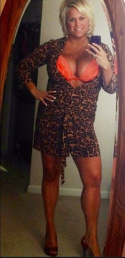 Curvy blonde cougar takes a selfie with her big tits showing