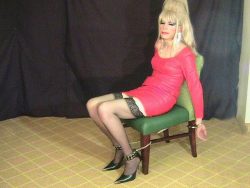 Red leather dress handcuffed to a chair