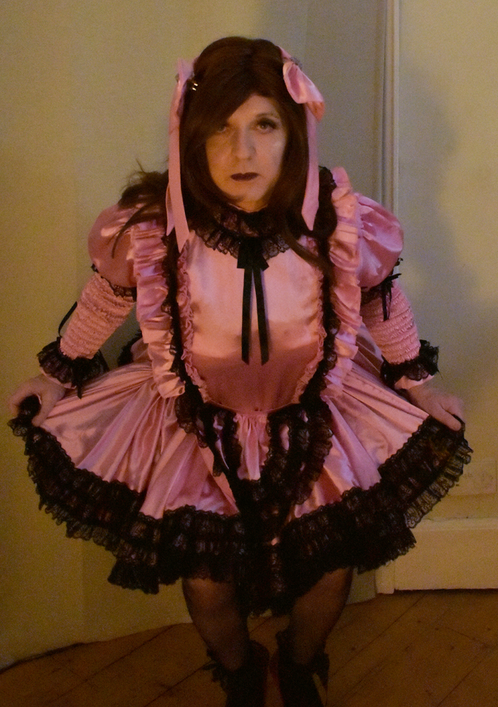 Dressed as a pink satin sissy maid to look pathetic
