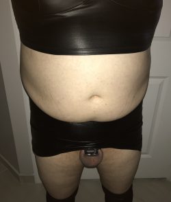 All black leather with a black micro chastity cage underneath her skirt. Cucky is matching!