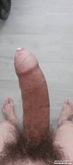 Big long uncut hard cock with precum leaking out the tip
