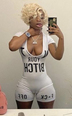 Slutty black bitch showing her titties and fat camel toe pussy