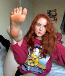 Pretty redhead making you sniff her feet