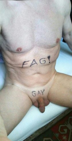 Faggot sits naked on the edge of the bed